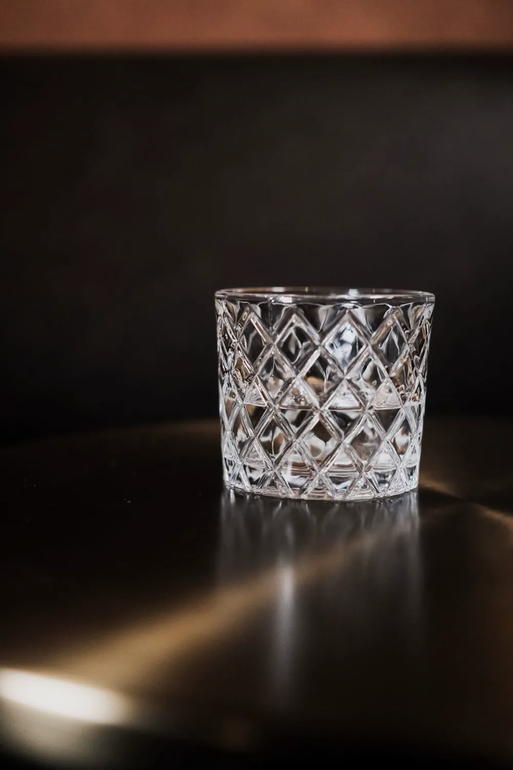 Crystal glass with clear vodka on a bar